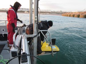 two archaeologists preparing to deploy a sub bottom profiler