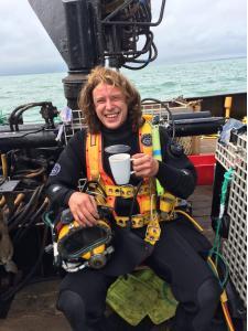 Tom Harrison in SCUBA gear on a boat