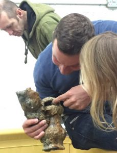 A diver shows a pewter jug to a child as part ofrooswijk engagement and training