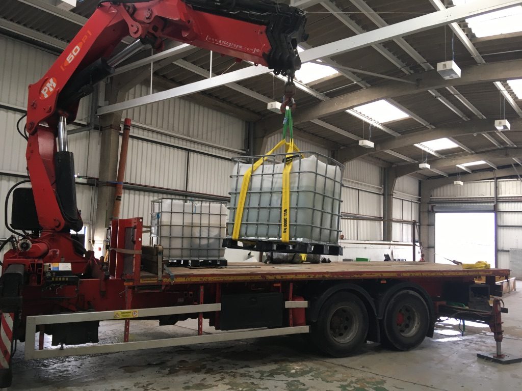 The second large artefact is lifted onto the lorry in its storage container