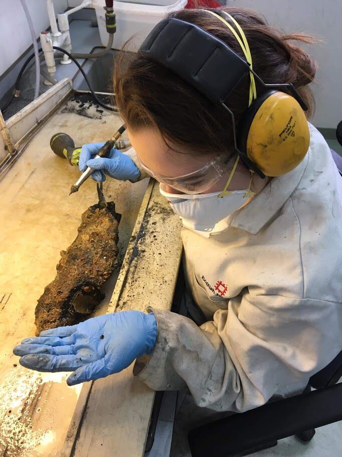 Posing with an uncovered copper bead (look at how small it is!)