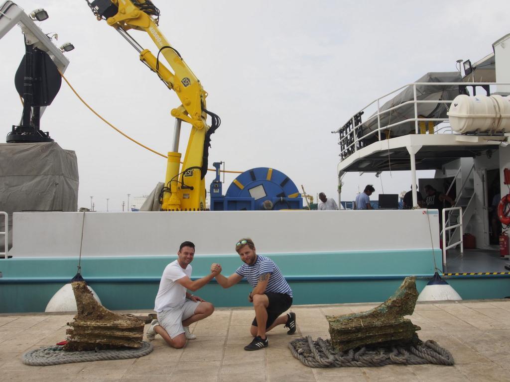 Mateusz Polakowski in front of a boat