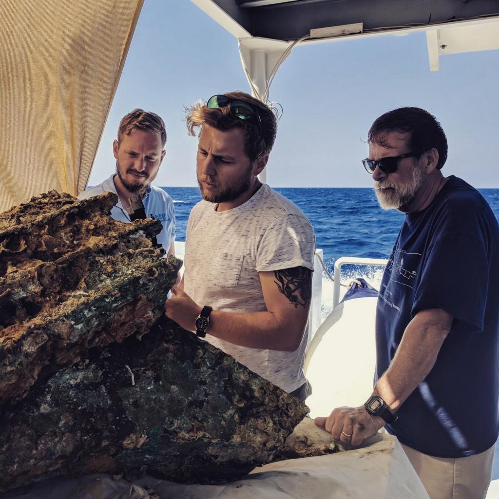 Mateusz Polakowski looking at a find from the seabed