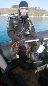 Adam Bolton in full SCUBA gear with cylinders funded by the 2019 recipient of the MSDS Marine grant award to support maritime archaeology students