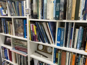 a picture of the MSDS Marine library featuring books, archaeological objects and a QR code