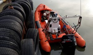 An orange boat beside a dock