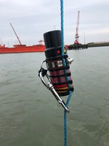 a sonardyne diver tracker attached to a blue rope