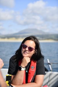 Alison James sitting on a boat and smiling