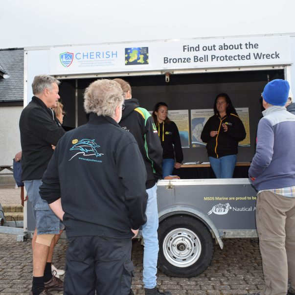 The Heritage Hive trailer shown parked at Hafan Pwllheli with a group of visiting divers