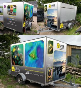 Three images showing the MSDS Marine outreach trailer from all sides. The trailer is a box trailer fitted out with audio visual equipment and activities